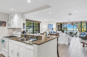 Beautiful End Unit with water views from all windows overlooks the Bay and Tropical Beach Setting condo